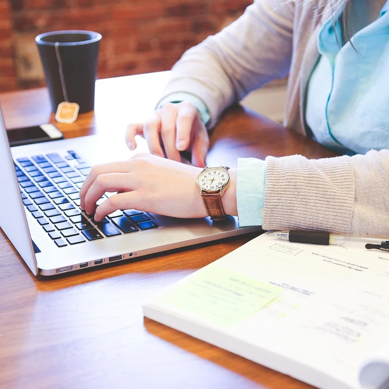 Professional writing personalized cold emails on a laptop for a Cumming GA business