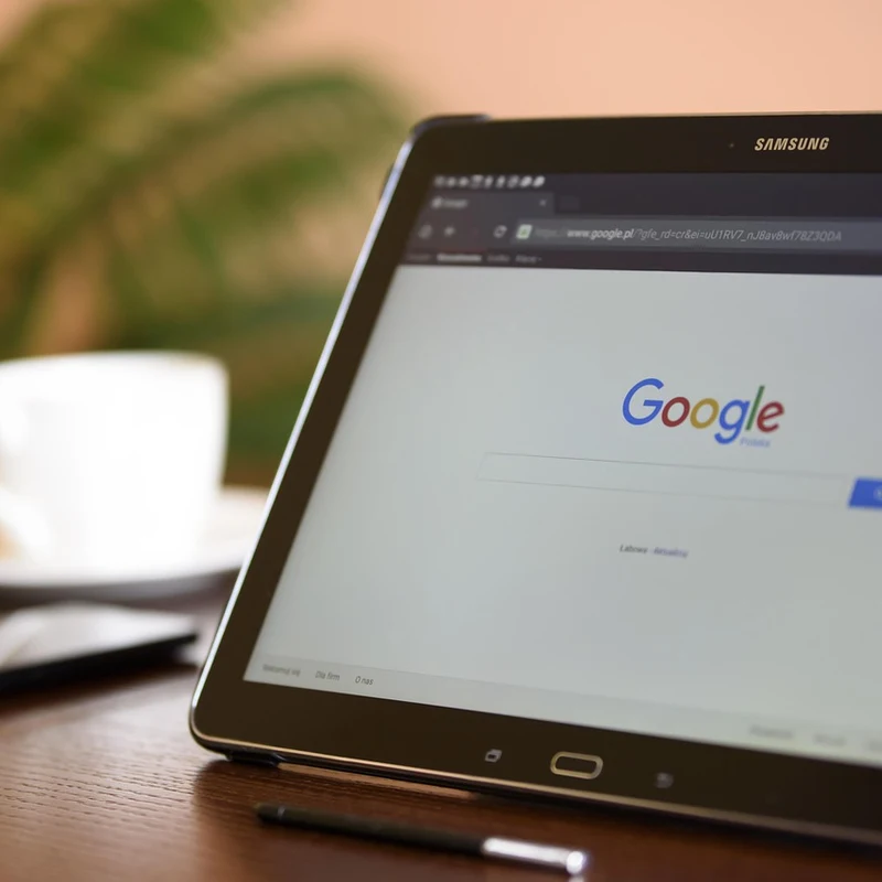 Searching for an available domain name for a Cumming GA business on a laptop