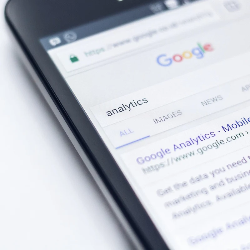 Smartphone showing local search results where a Cumming GA business profile needs optimization