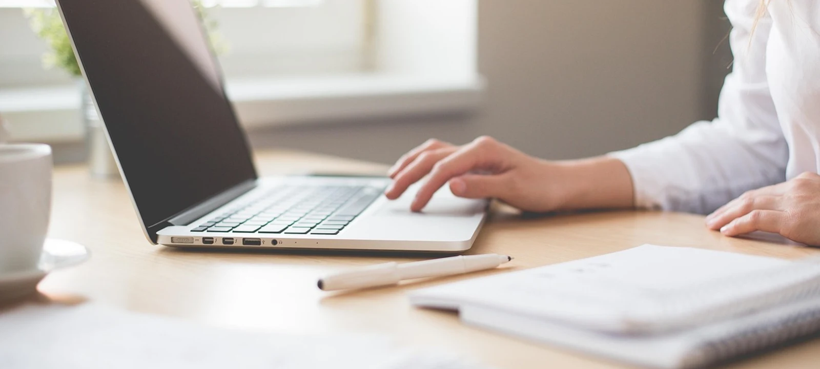 Web designer redesigning a Cumming GA business website on a laptop with a modern mockup