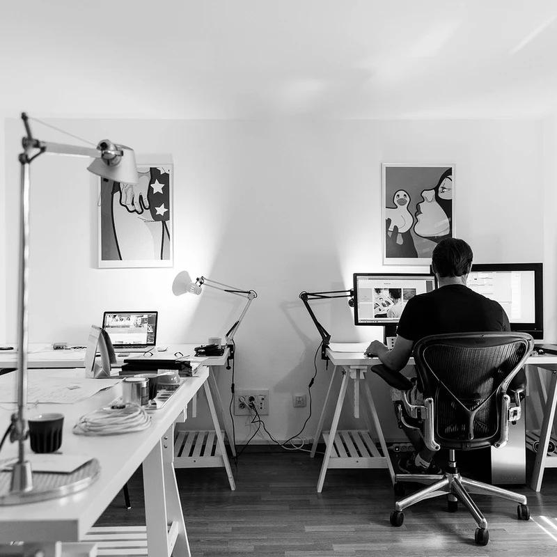 Web designer redesigning a Cumming GA business website at a modern desk